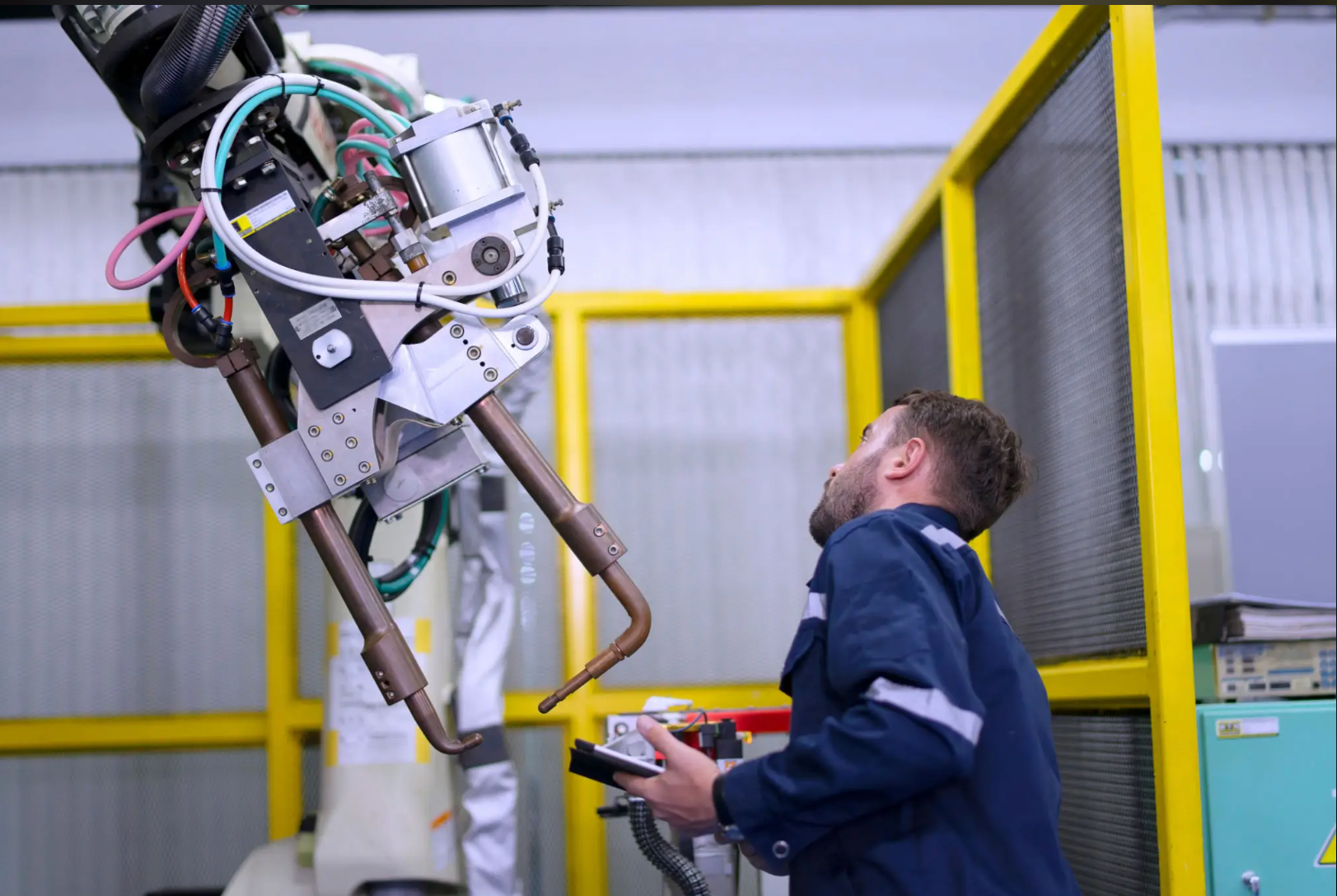 Engineer working with industrial robotic equipment