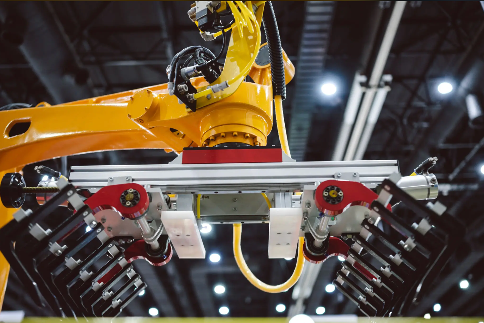 Industrial robotic arm with a gripper in a manufacturing facility